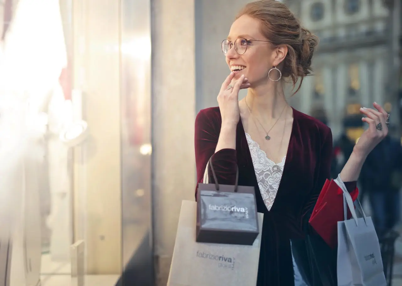 image of a smiling lady holding shopping bags